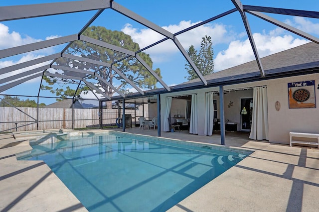 view of pool featuring a patio area, ceiling fan, and a lanai