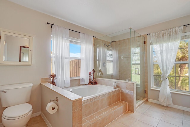 bathroom featuring plus walk in shower, tile patterned floors, and toilet