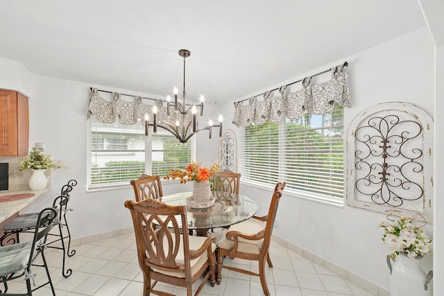 dining room with light tile patterned floors and an inviting chandelier