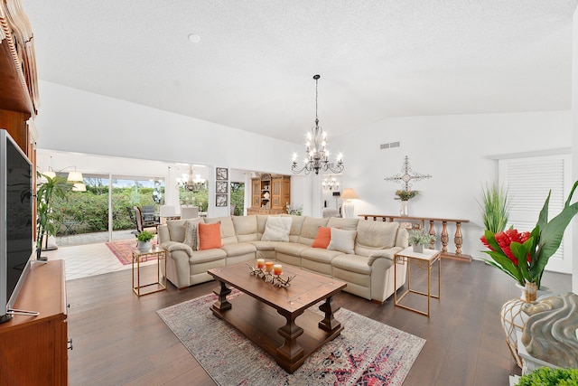 living room with a notable chandelier, dark hardwood / wood-style floors, a textured ceiling, and vaulted ceiling