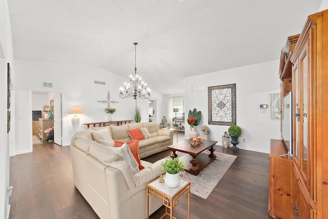 living room featuring a chandelier, a textured ceiling, dark hardwood / wood-style flooring, and vaulted ceiling