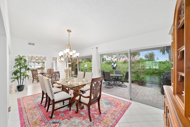 dining area featuring a textured ceiling, an inviting chandelier, lofted ceiling, and light tile patterned flooring