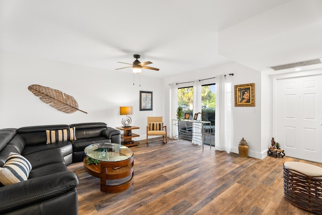 living room with ceiling fan and dark wood-type flooring