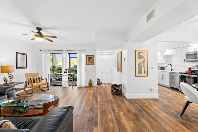 living room with ceiling fan, wood-type flooring, and sink