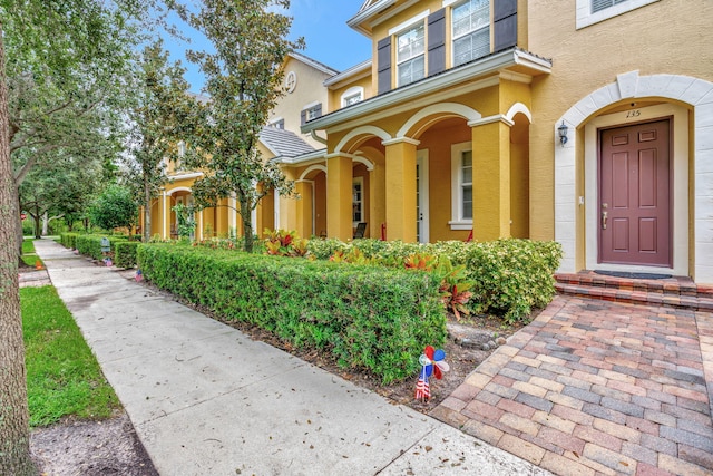 entrance to property with stucco siding