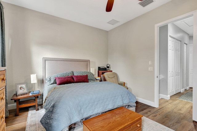 bedroom featuring ceiling fan, hardwood / wood-style floors, and a closet