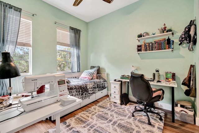 bedroom with ceiling fan and hardwood / wood-style floors