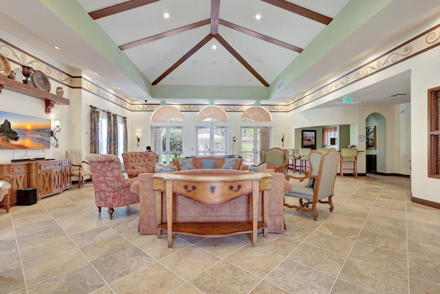 living room featuring french doors and high vaulted ceiling