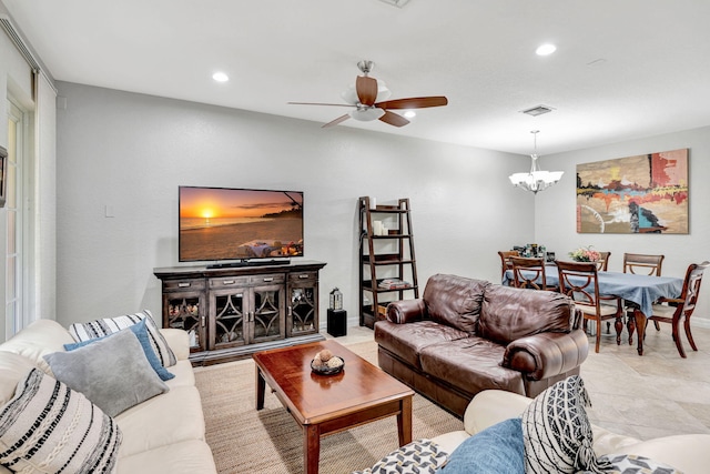 living room featuring ceiling fan with notable chandelier