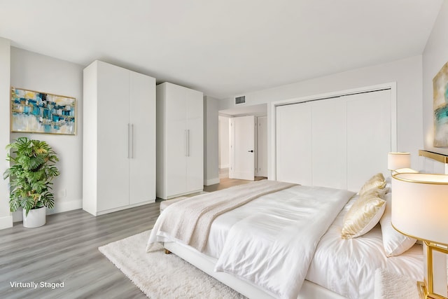 1180 S Ocean Blvd Unit 15B, Boca Raton, FL 33432 - bedroom featuring light wood finished floors, a closet, and baseboards
