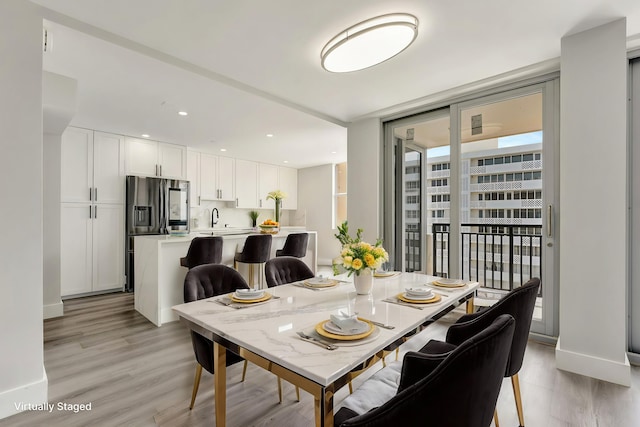 1180 S Ocean Blvd Unit 15B, Boca Raton, FL 33432 - dining area with light wood finished floors, floor to ceiling windows, and baseboards