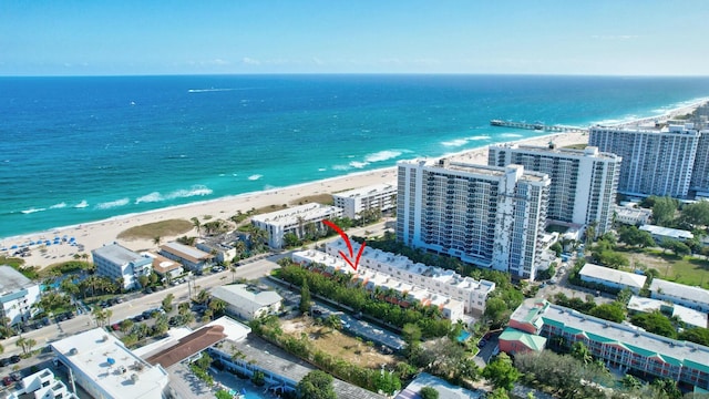 birds eye view of property with a water view and a view of the beach