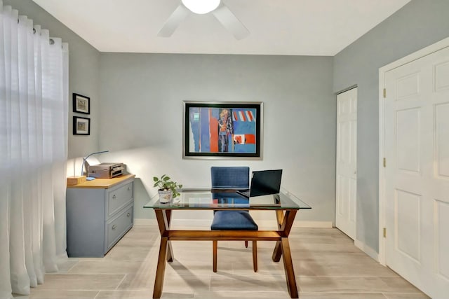 home office featuring ceiling fan and light hardwood / wood-style flooring