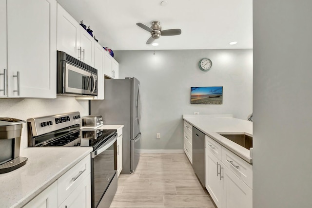 kitchen with ceiling fan, white cabinetry, and appliances with stainless steel finishes