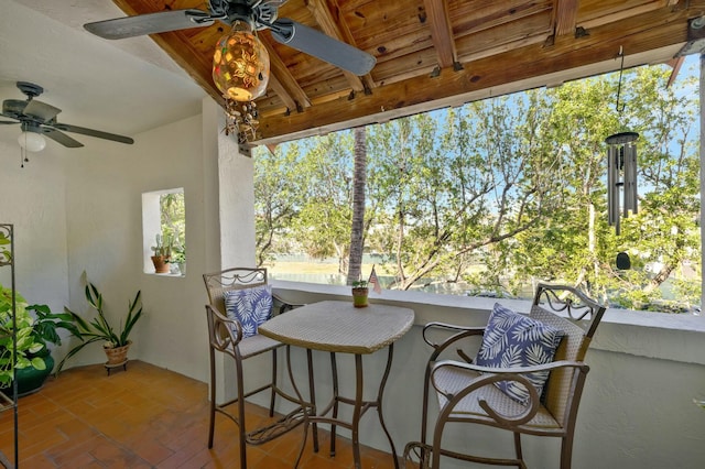 sunroom / solarium with a wealth of natural light and ceiling fan