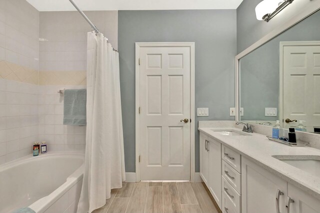 bathroom with shower / tub combo and vanity