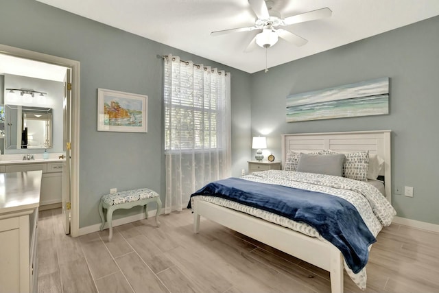 bedroom featuring ceiling fan, sink, and ensuite bathroom