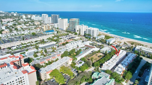 drone / aerial view with a water view and a beach view