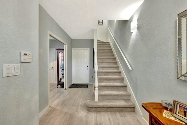 stairway featuring hardwood / wood-style flooring