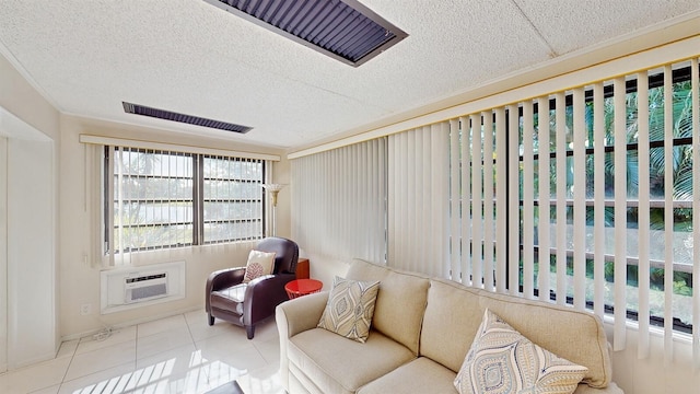 living room with a wall mounted AC and light tile patterned flooring