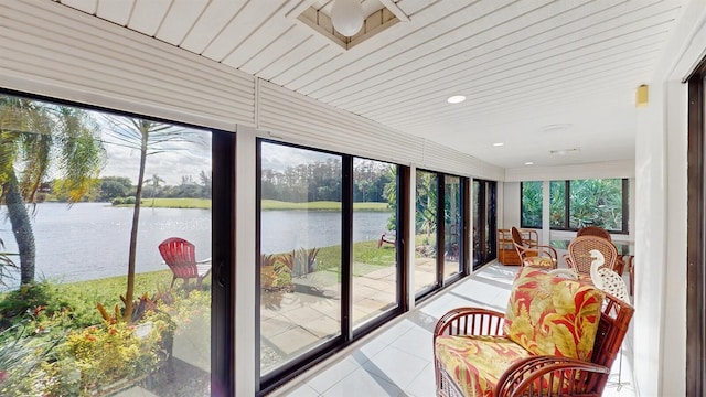 sunroom / solarium with a water view and wood ceiling