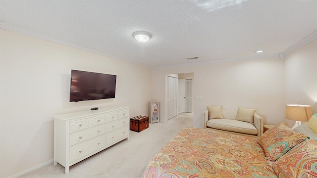 bedroom featuring light colored carpet, crown molding, and a textured ceiling