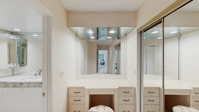 bathroom featuring a textured ceiling and vanity