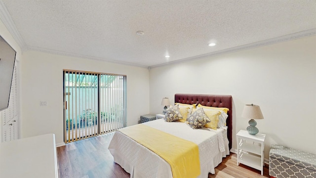 bedroom featuring light hardwood / wood-style flooring, access to exterior, a textured ceiling, and ornamental molding