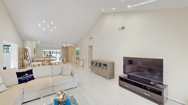 living room featuring light tile patterned floors and high vaulted ceiling