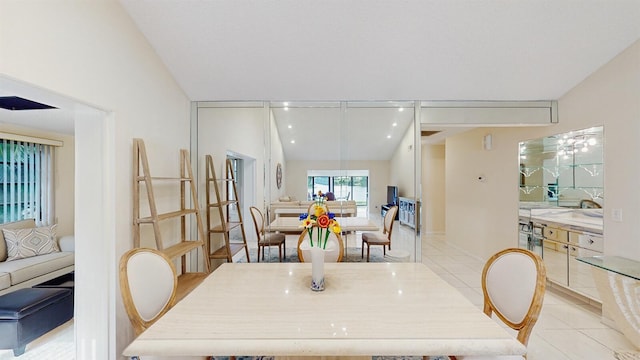 tiled dining space featuring vaulted ceiling