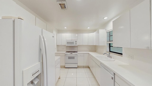 kitchen featuring white cabinetry, sink, white appliances, and light tile patterned floors