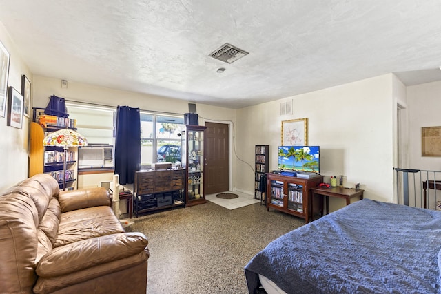 bedroom featuring cooling unit and a textured ceiling