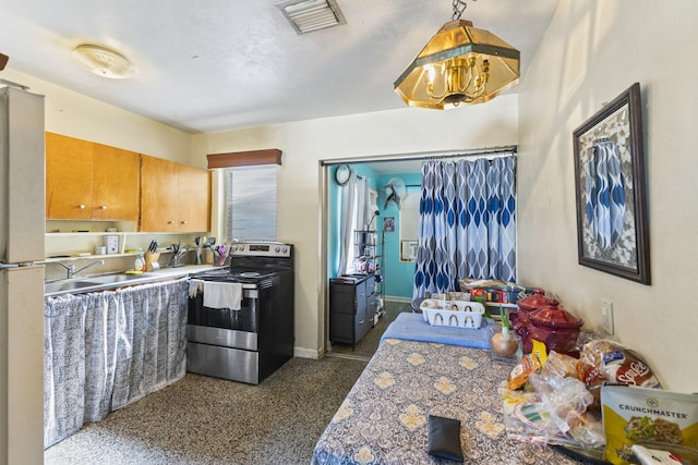 kitchen featuring white refrigerator, decorative light fixtures, stainless steel range with electric cooktop, and sink