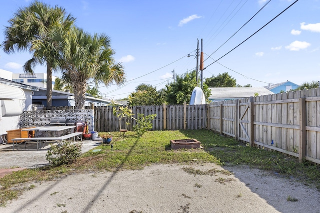 view of yard with a fire pit and a patio