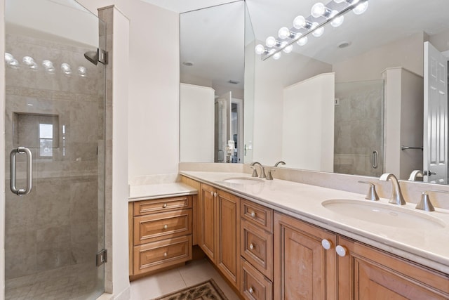 bathroom featuring tile patterned flooring, vanity, and an enclosed shower