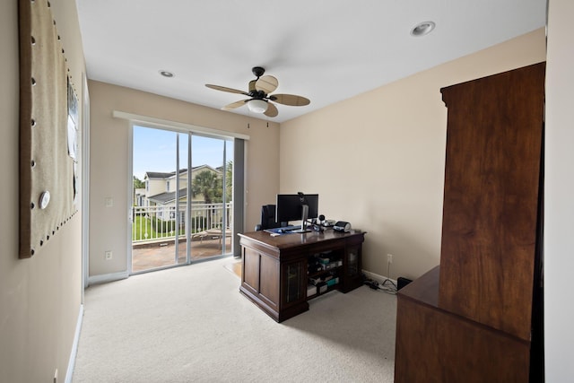 office space featuring ceiling fan and light carpet