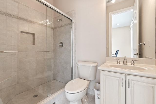 bathroom with vanity, a shower with shower door, and toilet