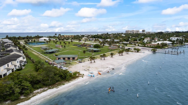 bird's eye view featuring a water view and a beach view