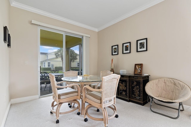 dining room featuring crown molding and light colored carpet