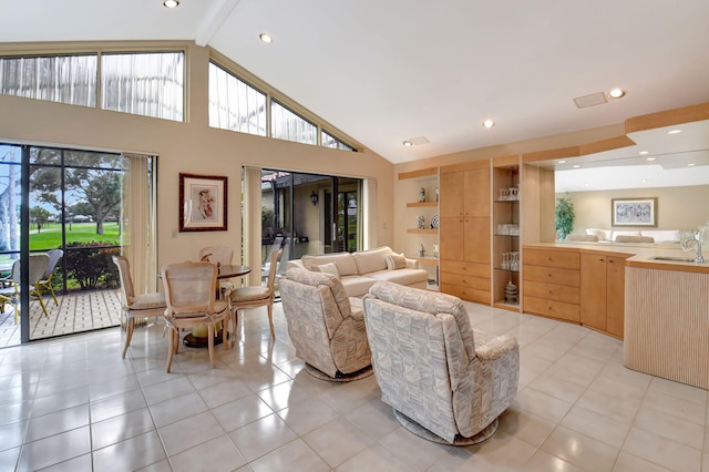 tiled living room featuring high vaulted ceiling, a healthy amount of sunlight, built in features, and sink