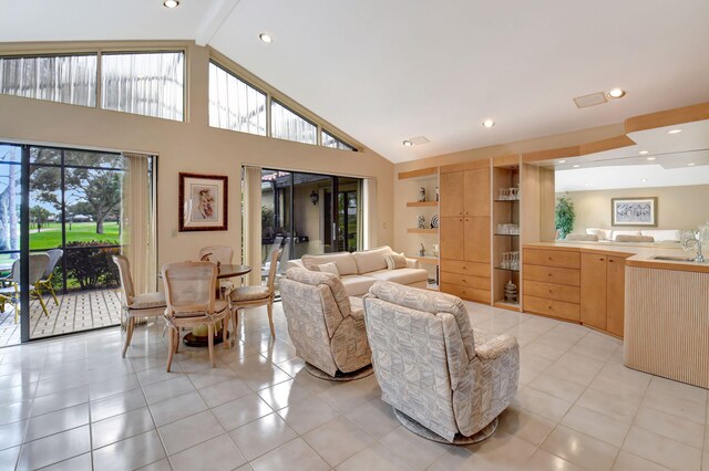 dining area featuring high vaulted ceiling and light tile patterned floors