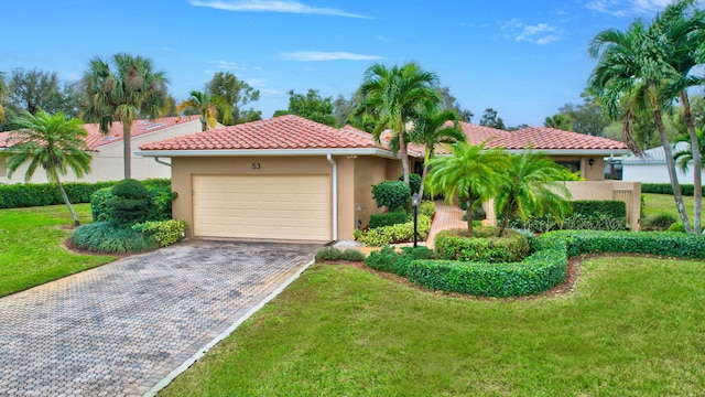 mediterranean / spanish-style house featuring a front yard and a garage