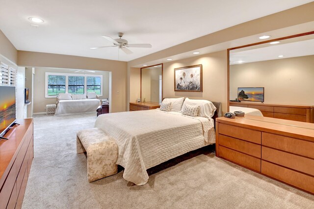 carpeted bedroom with ceiling fan and access to outside