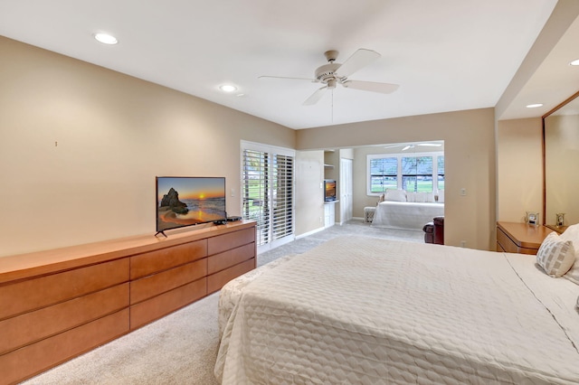 bedroom with ceiling fan, light colored carpet, and a closet