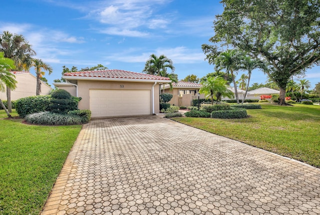 mediterranean / spanish-style house with a front lawn and a garage