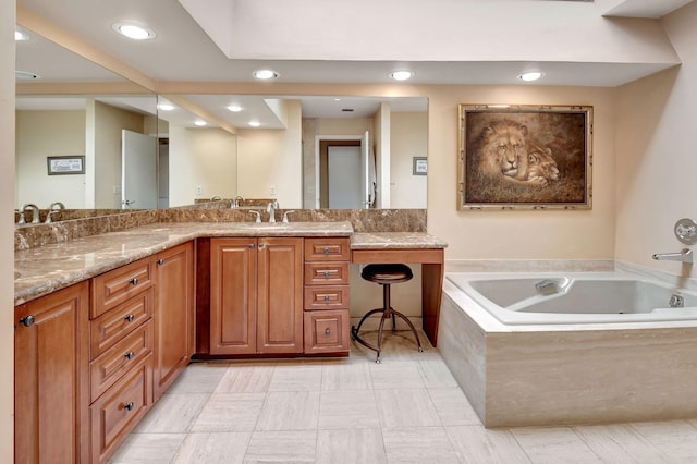 bathroom featuring vanity, tile patterned floors, and a relaxing tiled tub