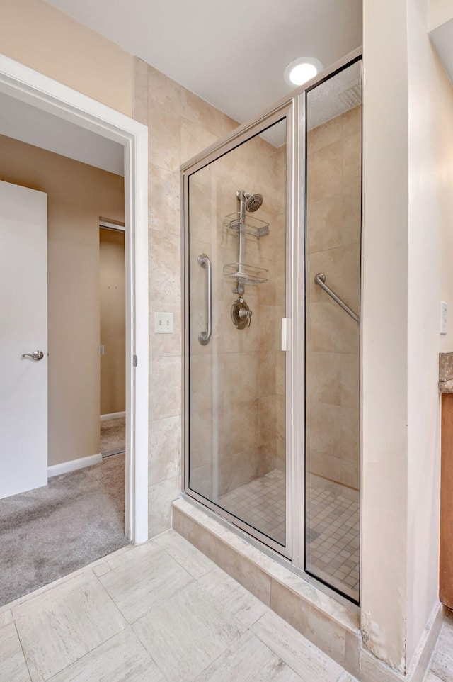 bathroom featuring a shower with shower door