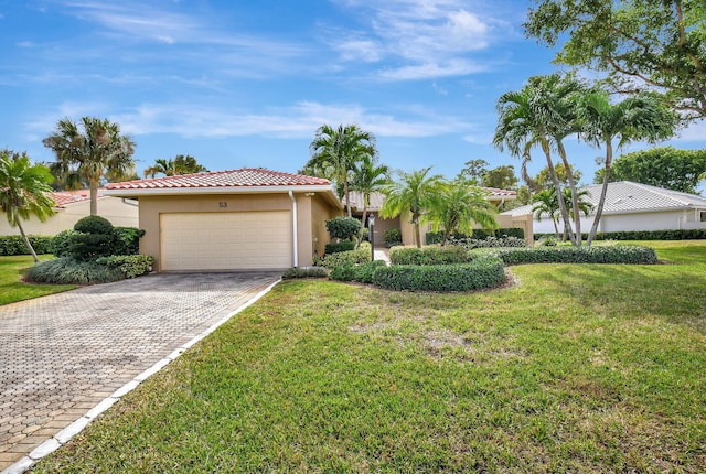 view of front facade featuring a front yard and a garage