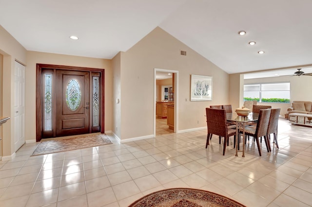 tiled entryway with ceiling fan and high vaulted ceiling