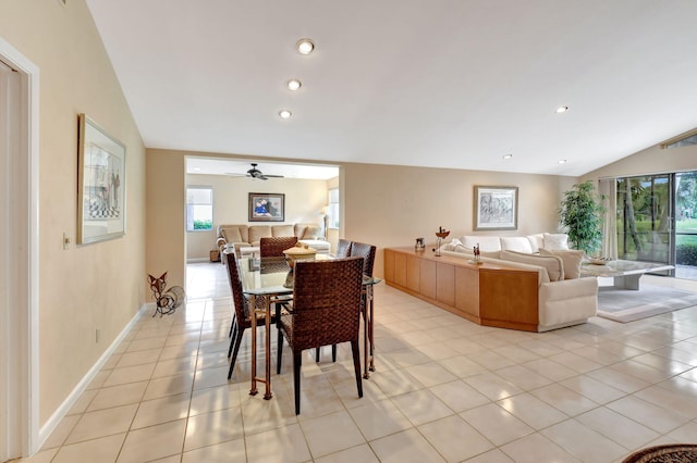 tiled dining area featuring ceiling fan and lofted ceiling